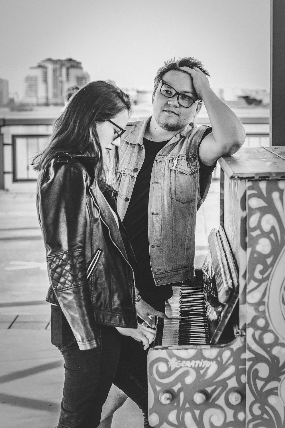 grey scale photography of man standing beside woman while facing woman