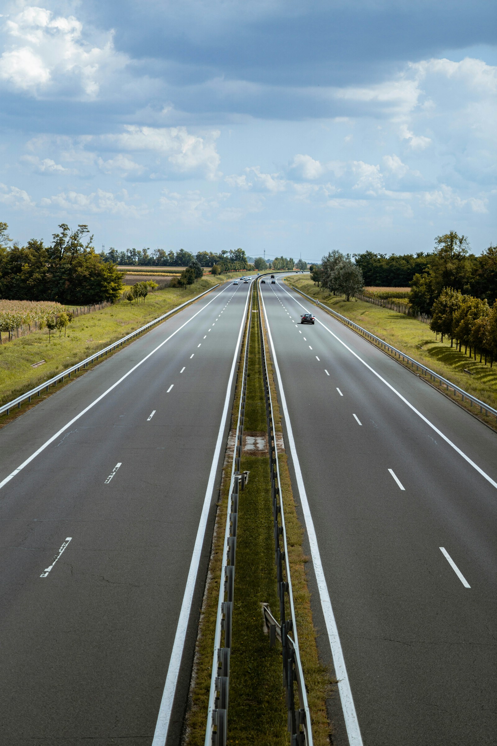 Dual carriageway highway with white edge lines and dashed lane markings