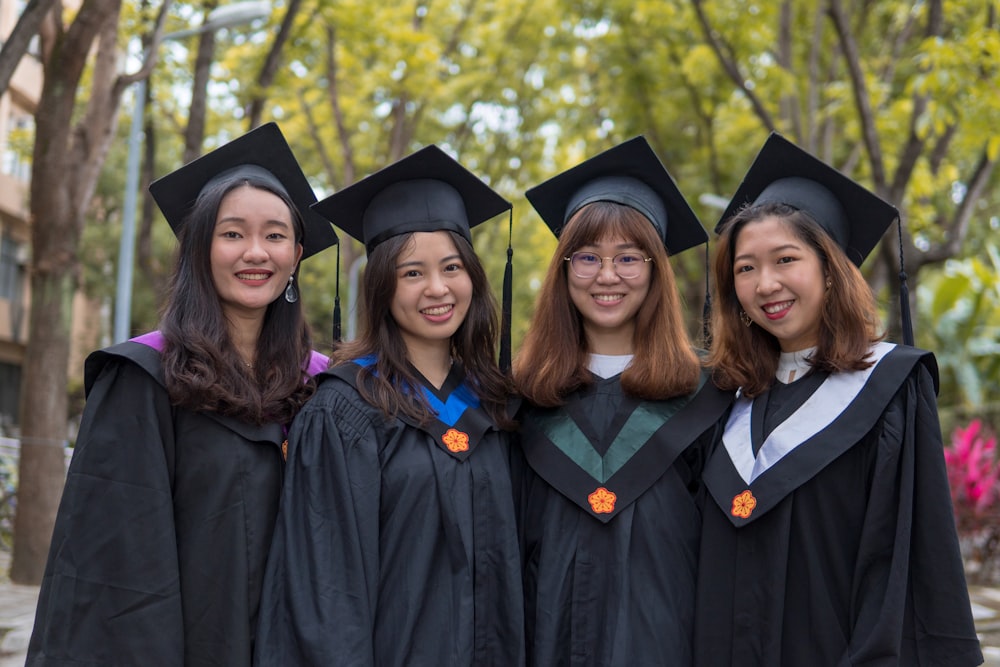 four women in wearing mortarboards