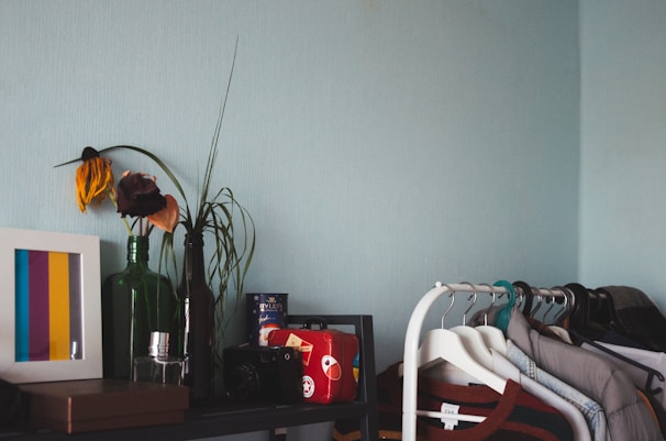 A neatly organized bedroom shelf showcasing soft linens and minimalist decor items