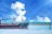 A cargo ship navigating through calm waters under a clear blue sky.