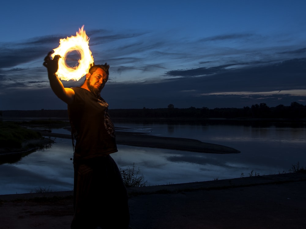 person holding ring with fire