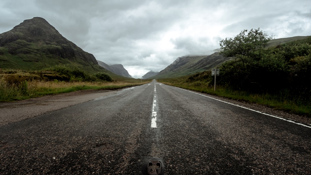 view of empty road between mountains