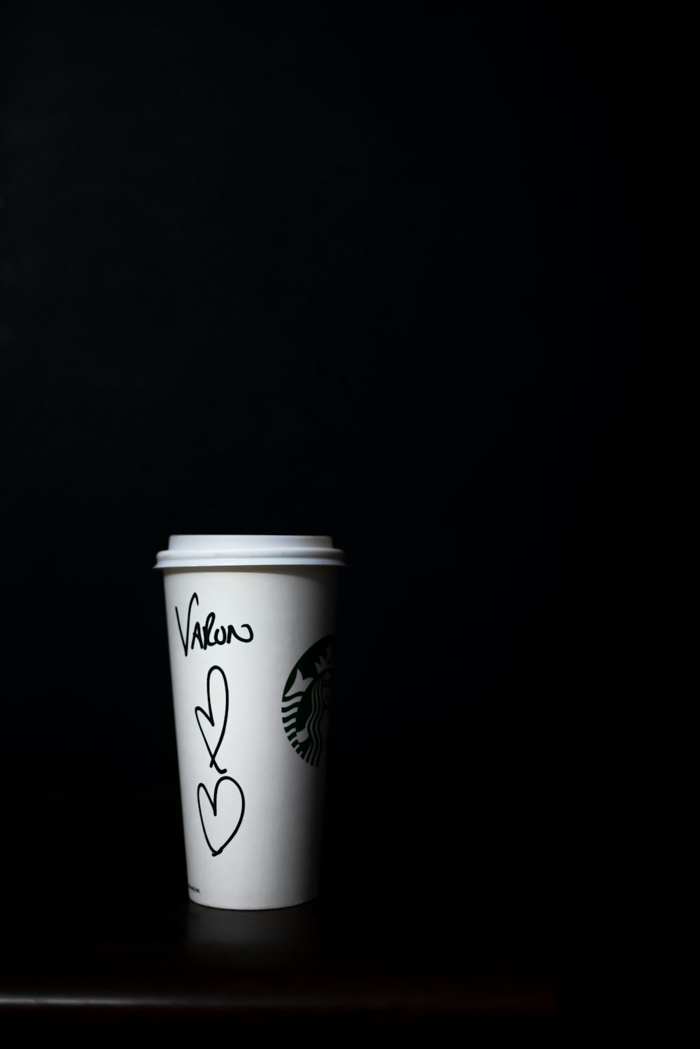 white Starbucks autographed disposable cup
