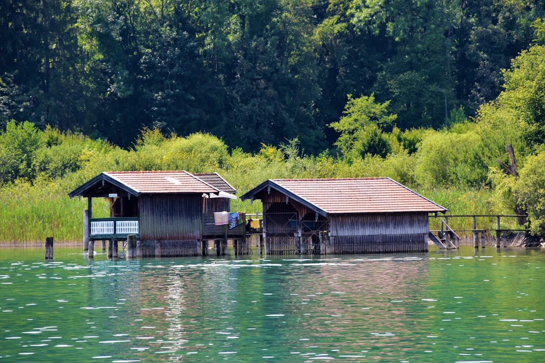 two wooden cottages at the lake,