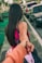 woman in pink dress and black tote bag