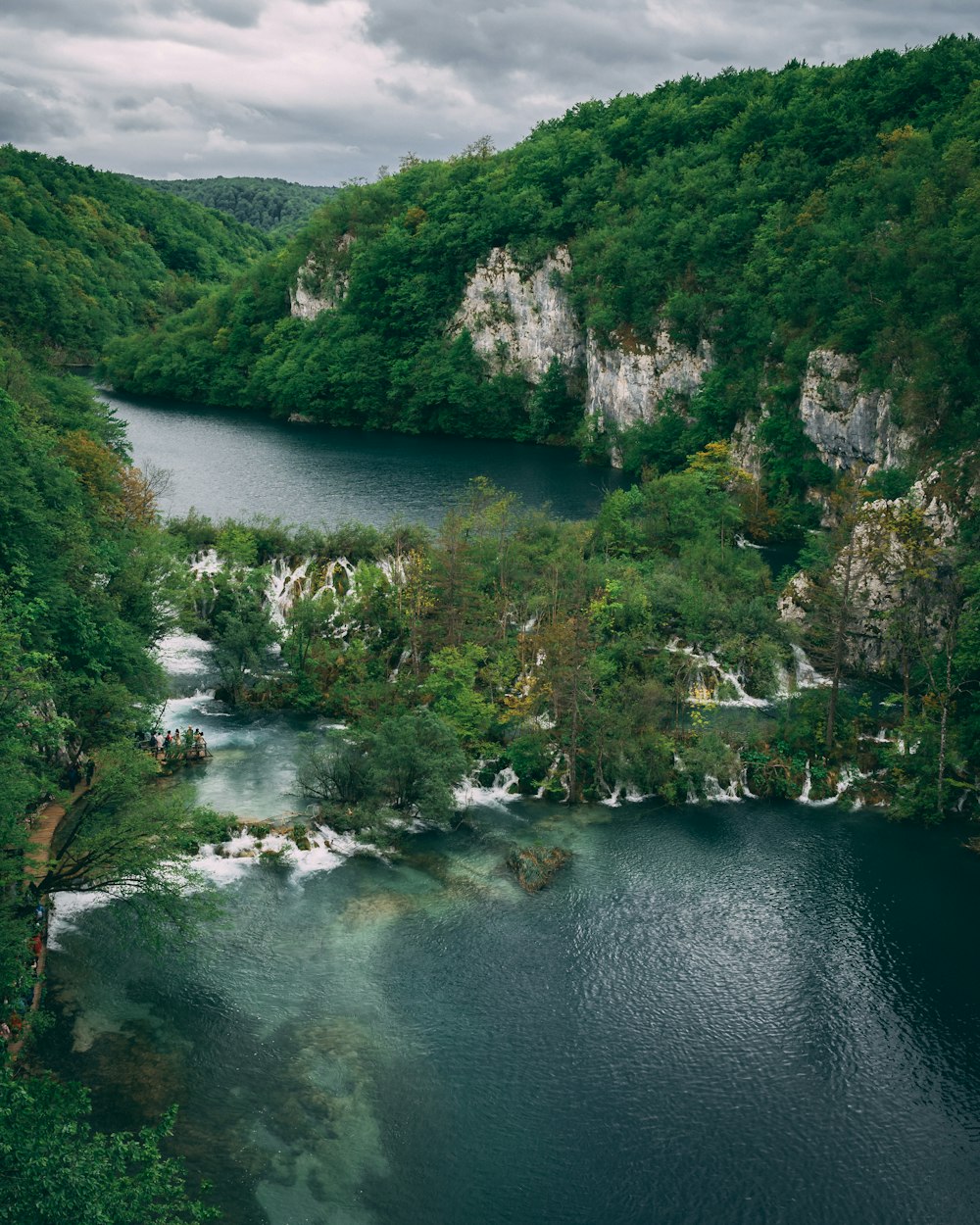 aerial photography of body of water surrounded by mountains