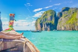 A peaceful boat ride through the emerald waters of Ha Long Bay under a clear blue sky.