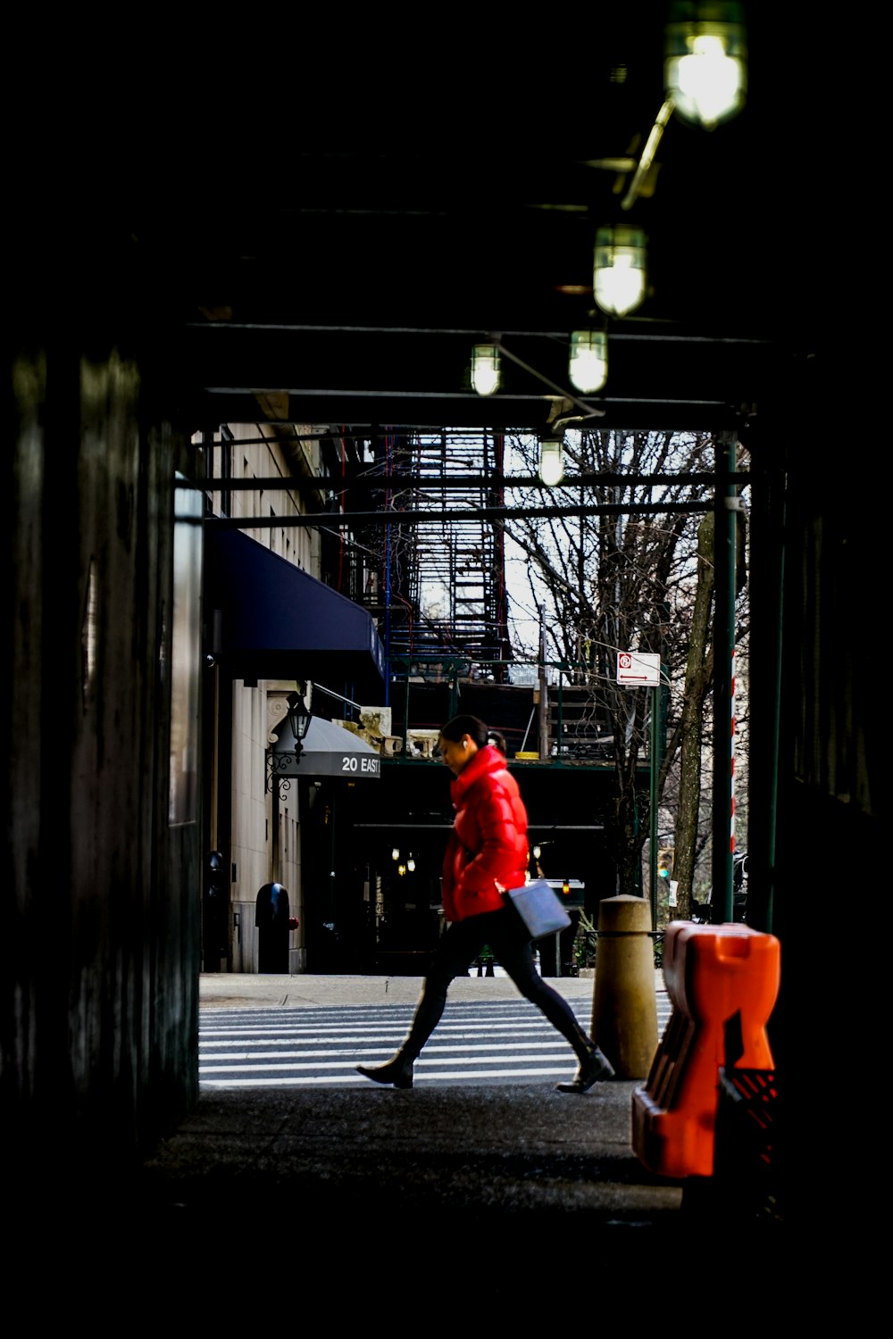 woman walking along sidewalk
