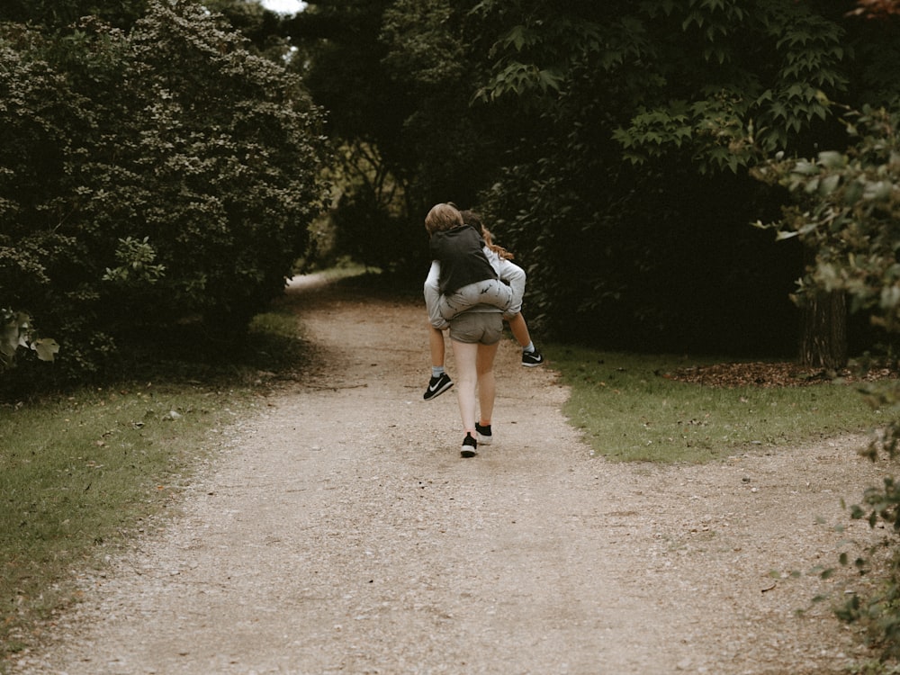 man carries woman on road