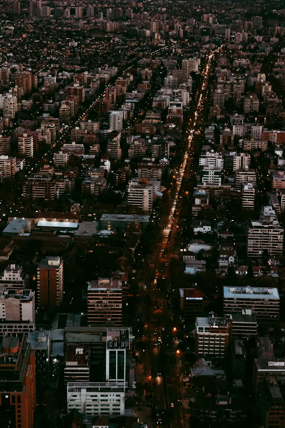 aerial photography of city with high-rise buildings during night time