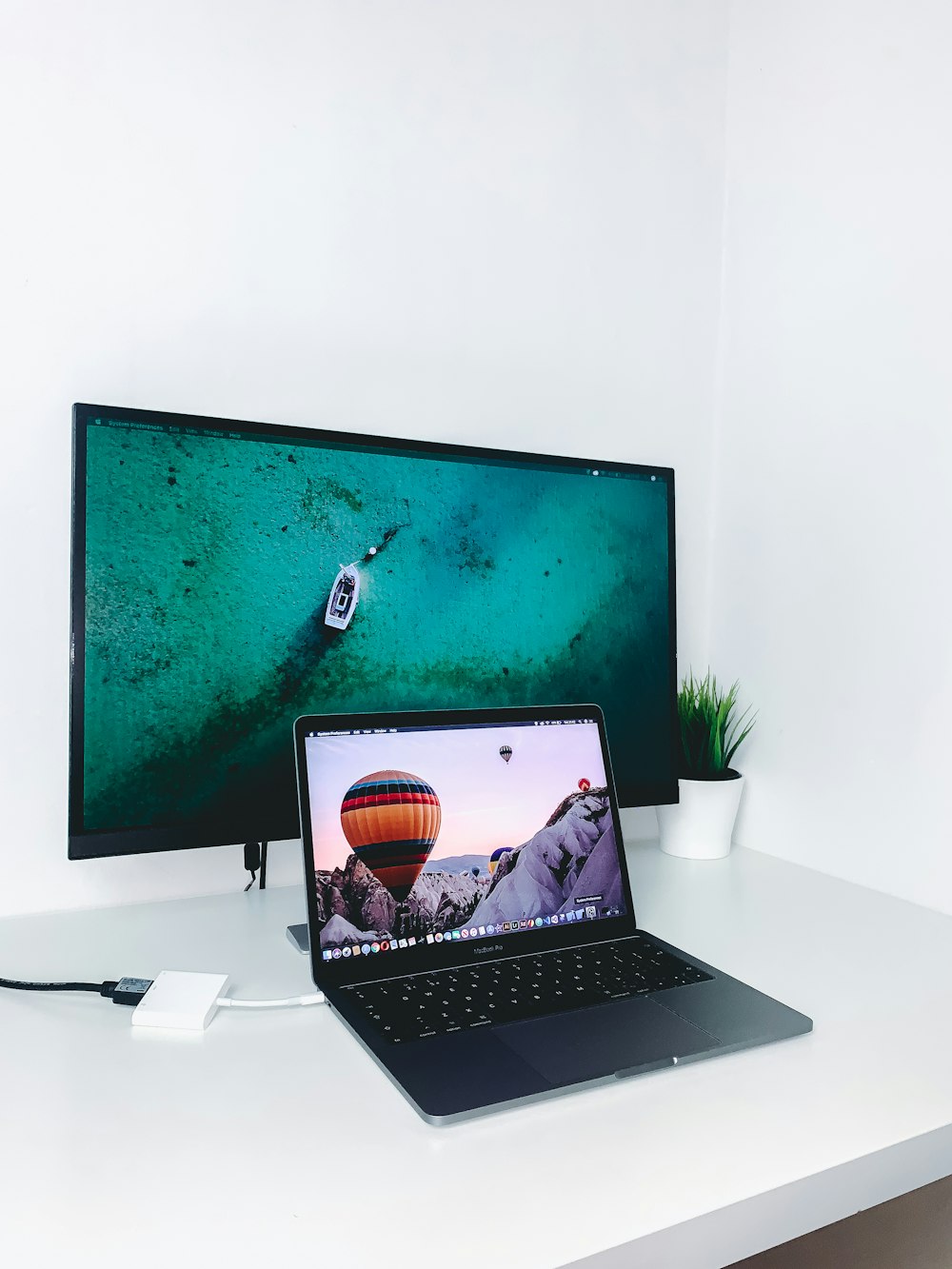 black laptop computer in front of TV