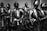 A group of suits of medieval armor stands in a display, each featuring intricate metalwork and detailed fittings typical of knight armor from the Middle Ages.