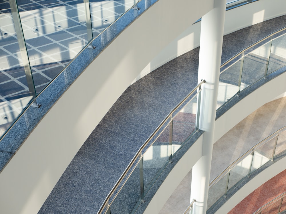 a spiral staircase in a building with glass balconies