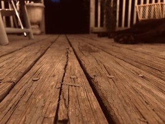 Close-up of large-sized Tuscan parquet planks in a warmly lit, rustic interior.