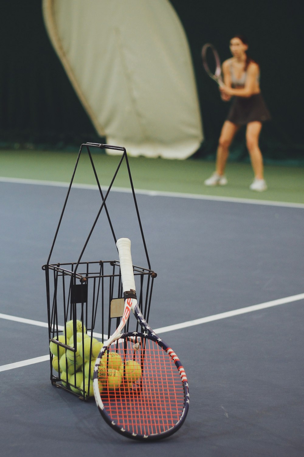 woman standing and holding tennis racket at the tennis court