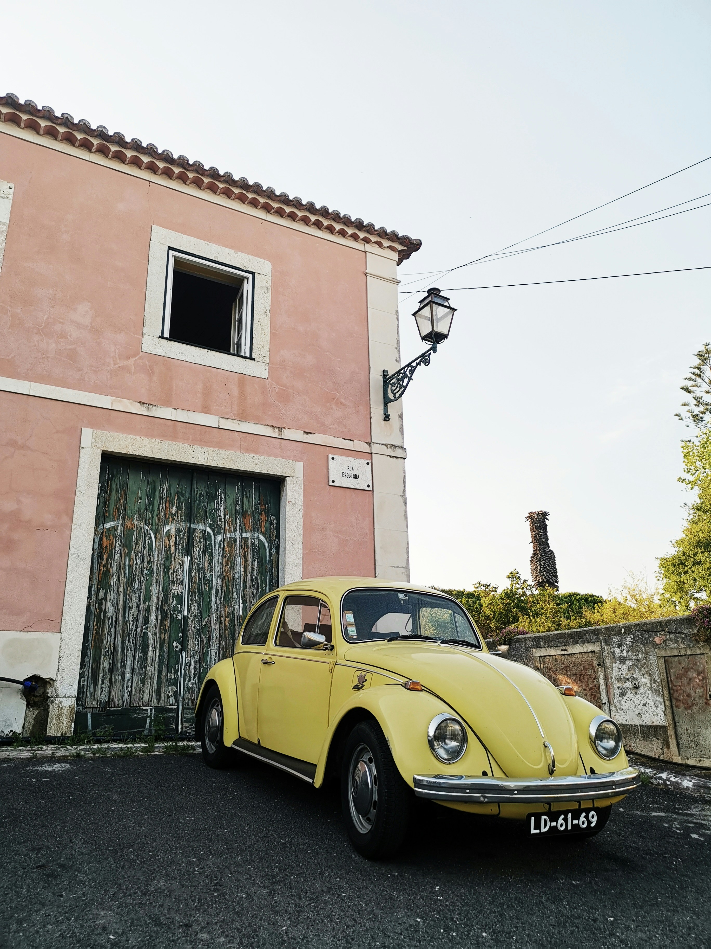 yellow Volkswagen Beetle parked on street