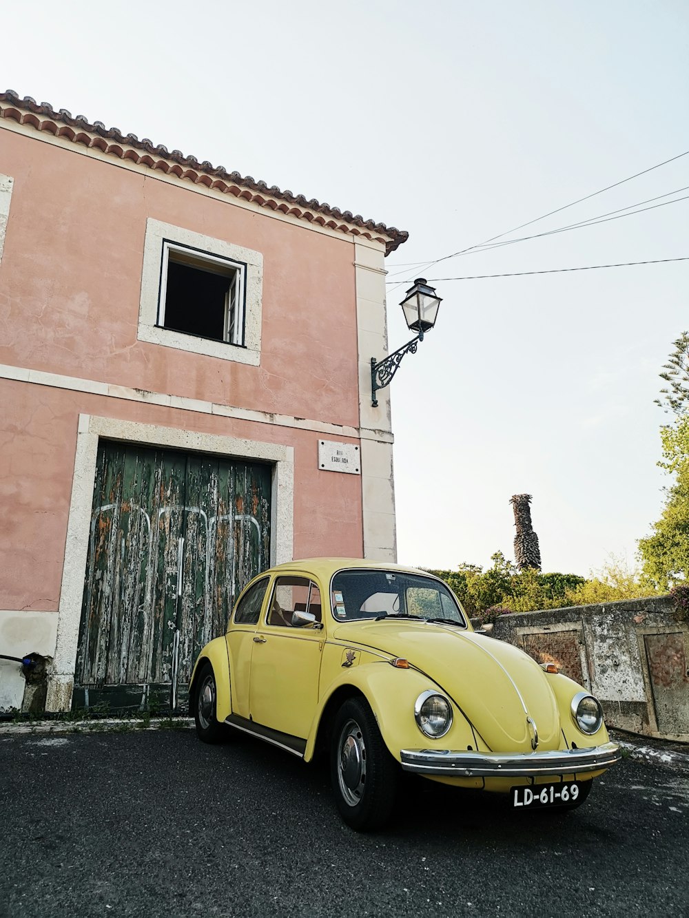yellow Volkswagen Beetle parked on street