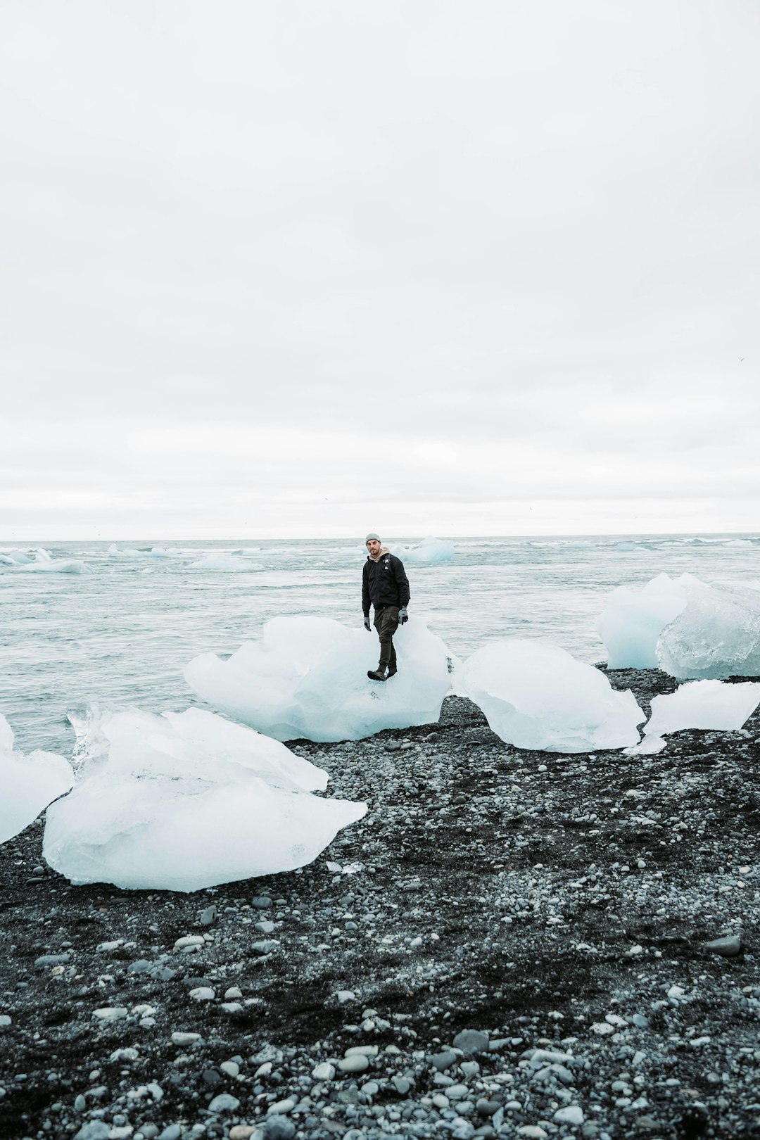 man standing on shore during daytime