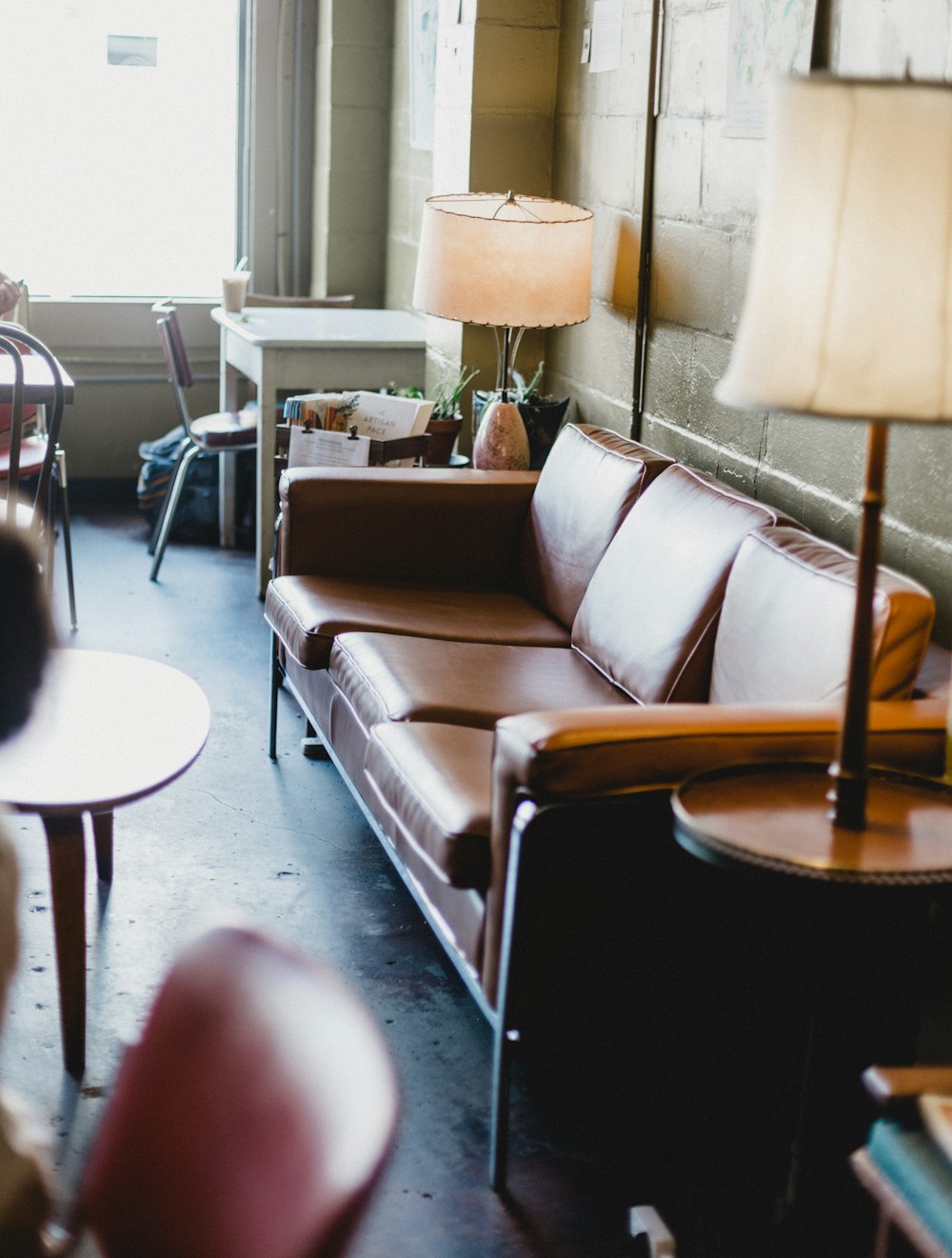 empty brown leather sofa and lamps inside room