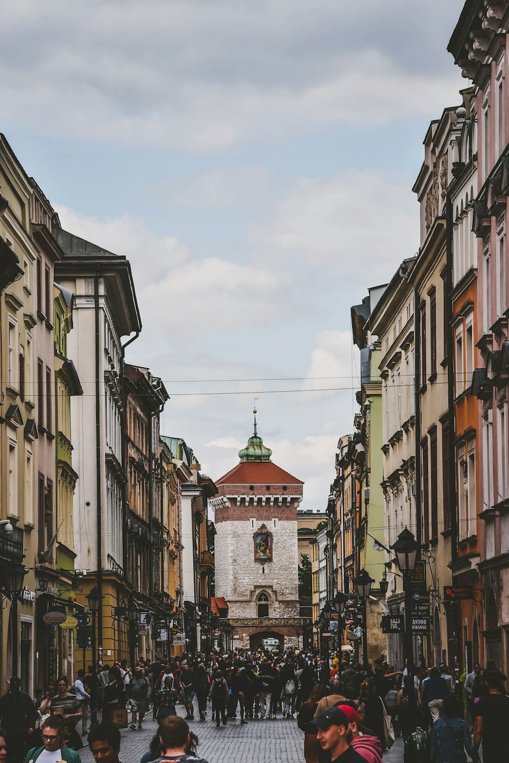 people walking beside buildings during daytime