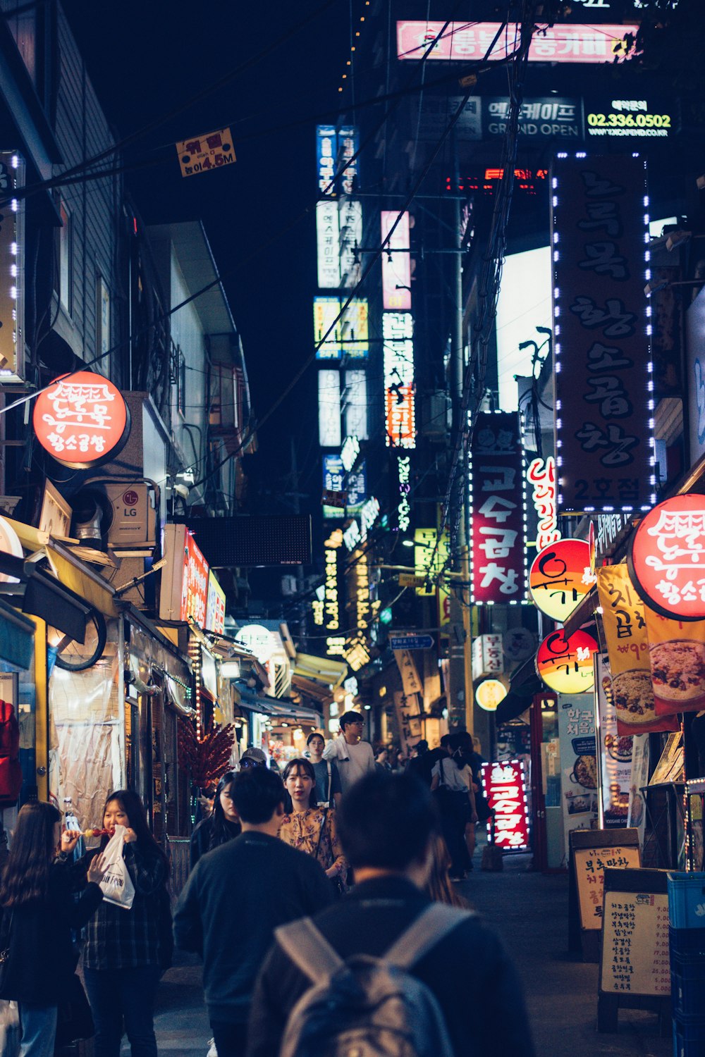 people walking on street at night