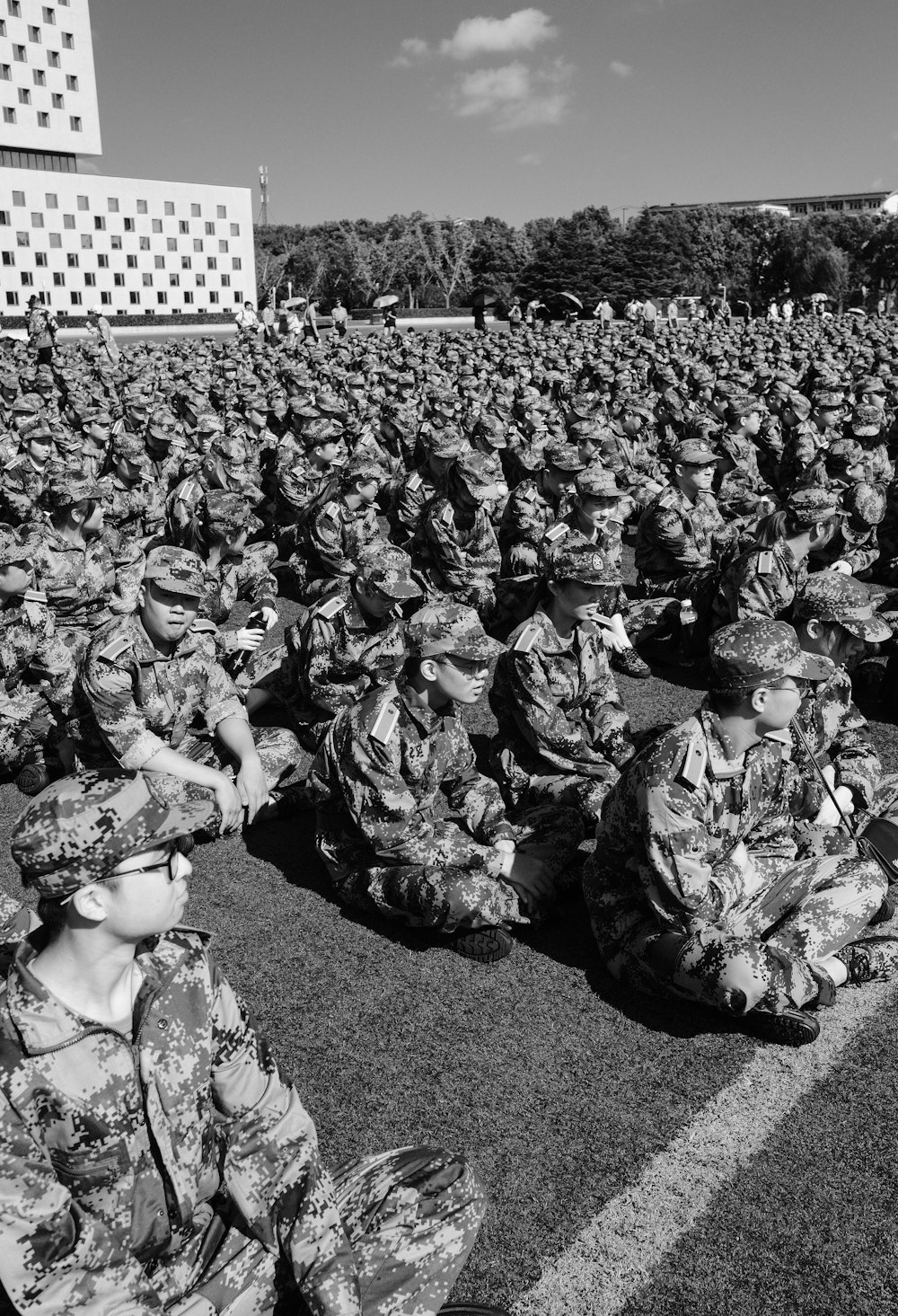 grayscale photography of men wearing camouflage service uniforms