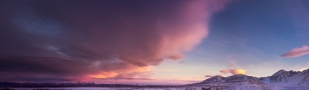 Una montagna coperta di neve sotto un cielo nuvoloso