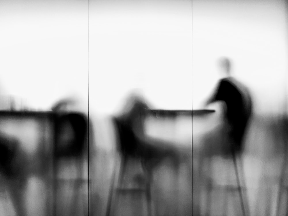 a blurry photo of a person sitting at a table