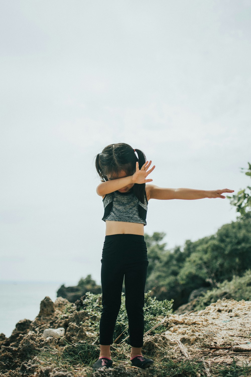 girl wearing gray top and black pants