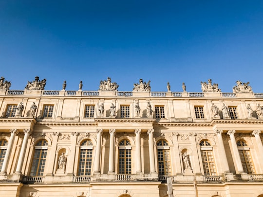 beige concrete building in Palace of Versailles France