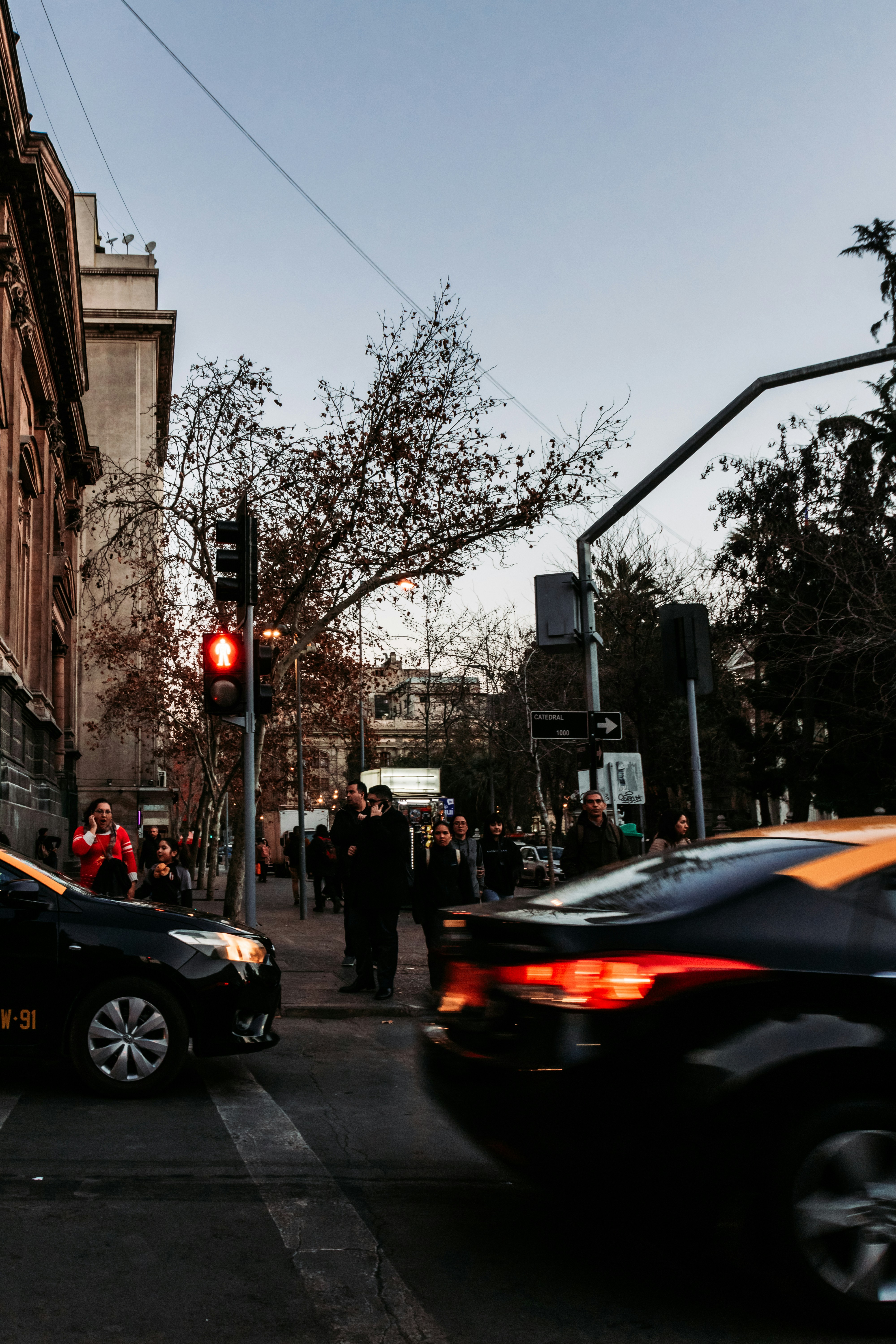 black cars passing on road during daytime