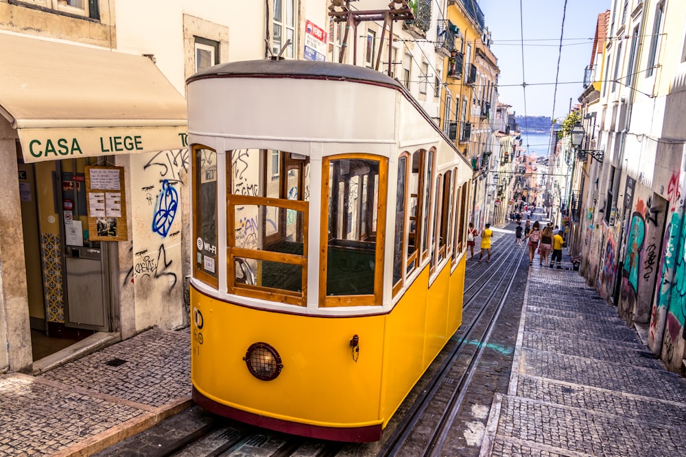 empty yellow tram during daytime