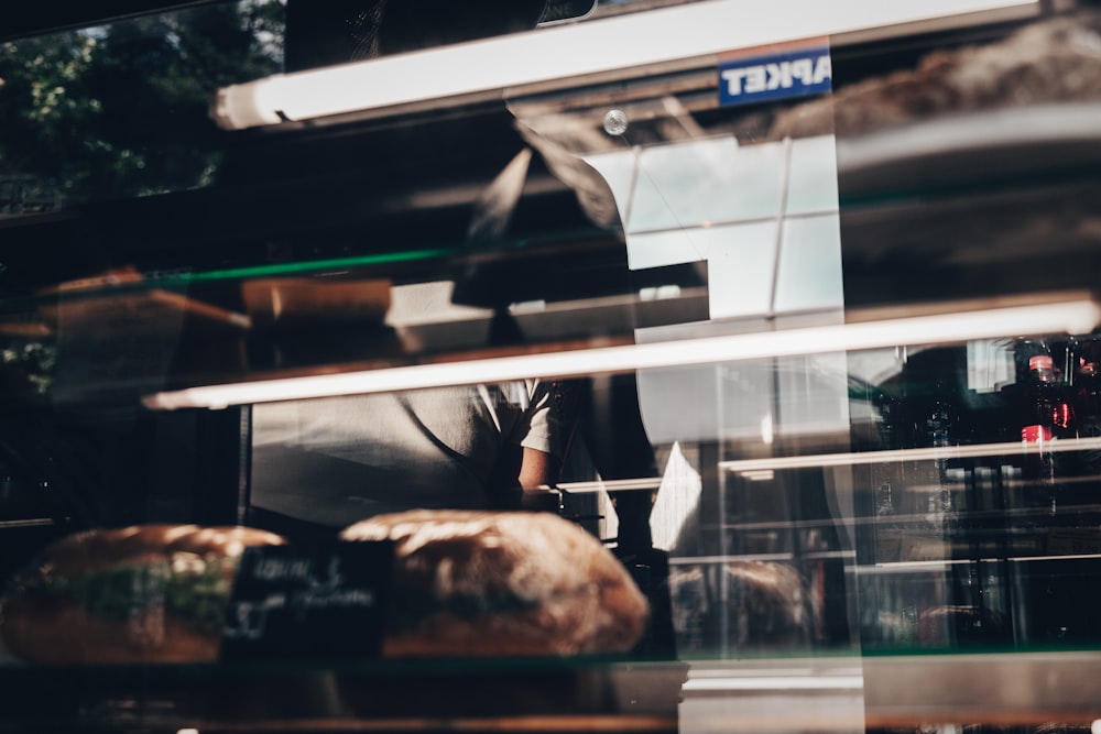 a man standing in front of a bakery window