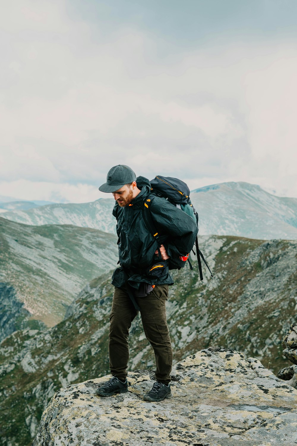 man standing on cliff during day