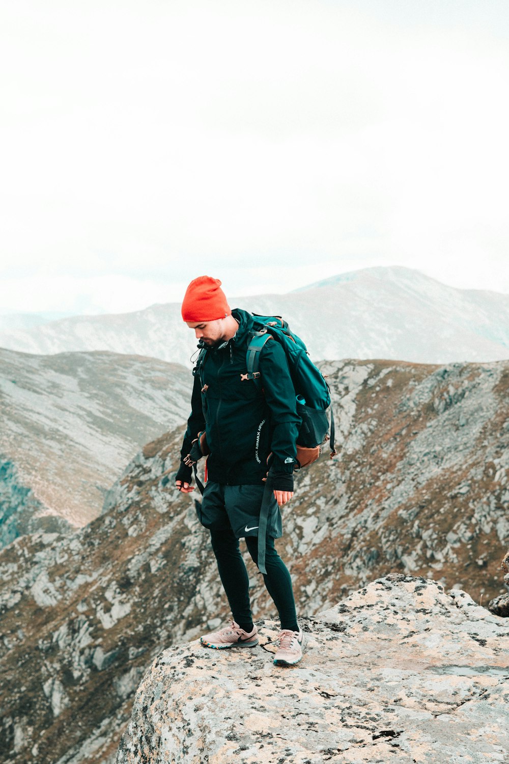 man wears orange knit cap