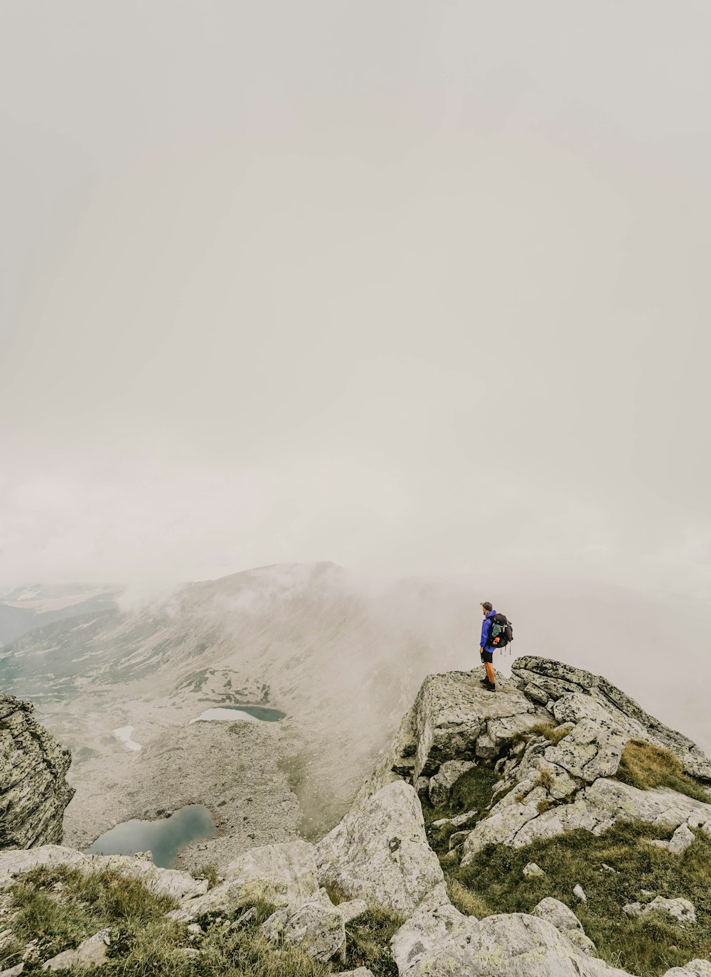 person standing on rock cliff