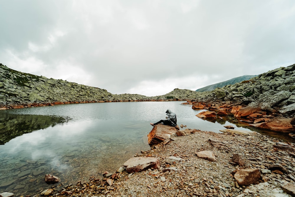 man sitting on rock