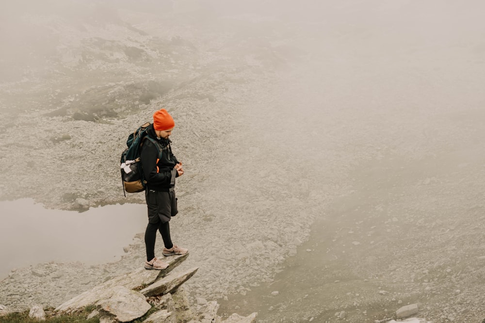 man standing on small stone hill