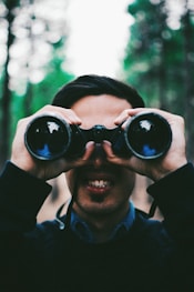 man using binoculars