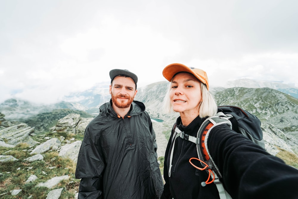 woman in black hoodie carrying backpack on mountian