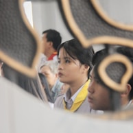 A group of people wearing elegant scarves at a cultural event.