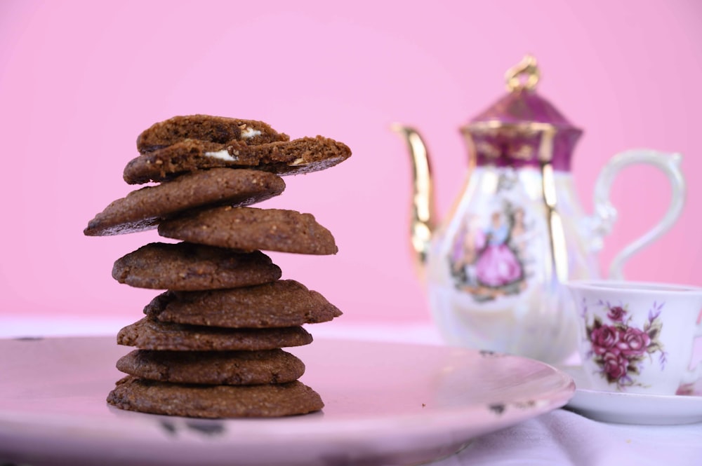 brown cookies on round pink ceramic plate
