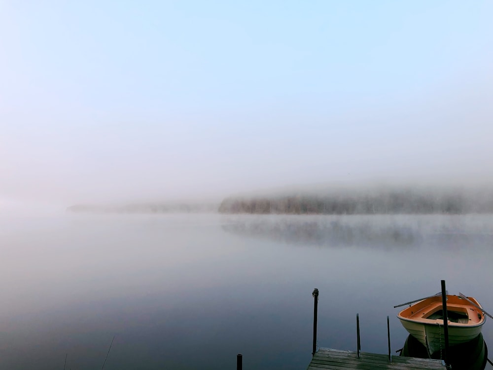 green and brown canoe on calm body of water