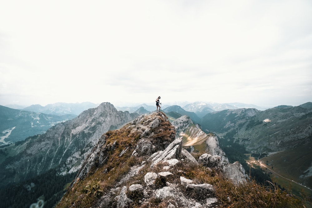 person standing on mountain during daytime