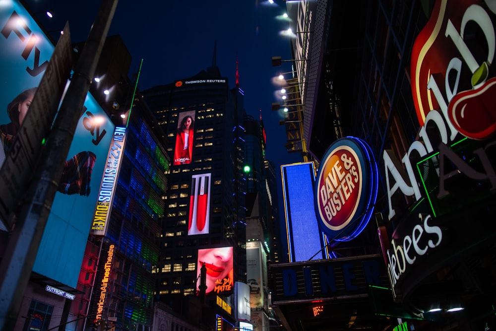 low-angle photography of electric billboards during night