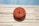 A red circular fire alarm, marked with 'Viking', is mounted on a textured, light beige brick wall. Above the alarm, the words 'Sprinkler Alarm' are visible, and the blue sky is in the background.