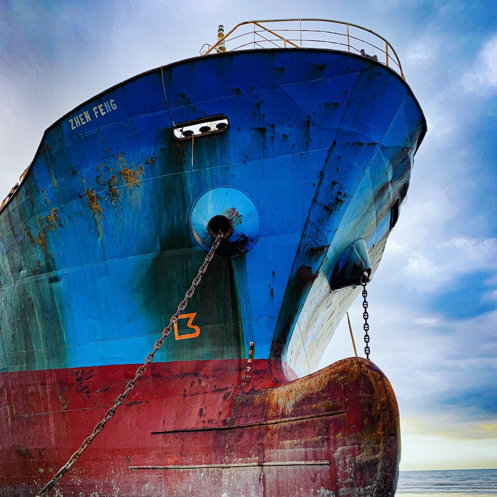 blue and red Zhen Feng ship during daytime