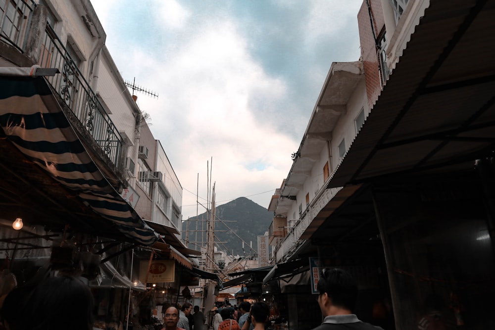 people walking between buildings during daytime