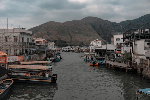 Local fishermen navigating wooden boats through narrow waterways.